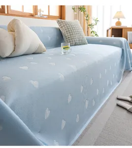Detail of light blue cooling sofa cover featuring white heart jacquard and knit texture