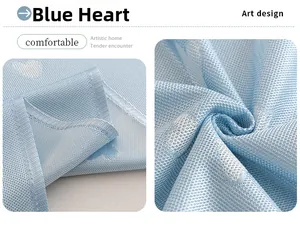 Close-up of blue cooling sofa cover fabric with white heart pattern and stitched edge