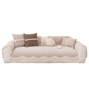Modern beige chenille sofa cover set with scalloped tassel edges and matching cushions