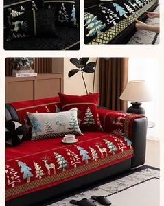 Detail of red chenille sofa cover featuring festive reindeer and Christmas tree patterns