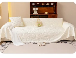 Detailed texture of cream quilted ice silk sofa cover with embossed feather pattern