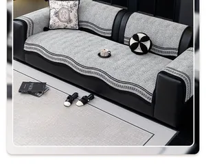Detail of grey chenille sofa cover with black and white geometric jacquard pattern edge