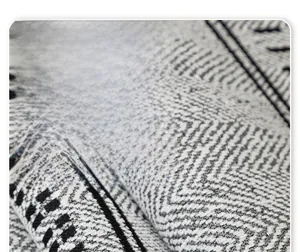 Macro shot of thick chenille sofa cover showing grey zigzag texture and heavy fabric