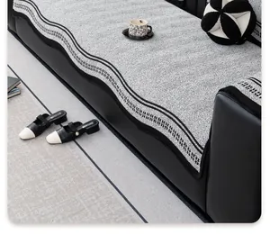 Close-up of chenille sofa cover showing black and white herringbone texture and wavy trim