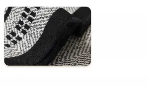 Macro shot of thickened black edge binding and geometric chenille sofa cover fabric