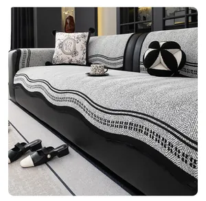 Detail of chenille sofa cover with black wavy edges and V-shaped woven texture