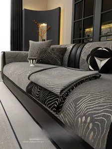 Close-up of grey chenille sofa cover showing wavy texture and black edge stitching detail