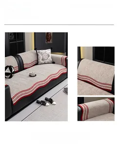 Close-up of beige chenille sofa cover showing thick knit texture and red stripe borders