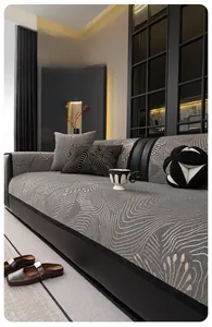 Close-up of gray chenille sofa cushion with beige wave patterns and black stitched edges