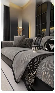 Close-up of chenille sofa cover showing deep grey abstract wave patterns and texture