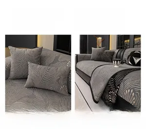 Detail of dark grey chenille sofa cover with woven wave pattern and black trim edge