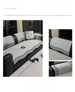 Detail of green chenille sofa cover with striped edges and luxury textured fabric