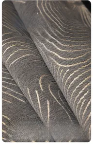 Detail of grey chenille sofa fabric with golden wave patterns and thick texture