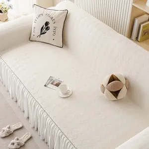 Creamy chenille sofa cover with diamond grid pattern and elegant ruffled skirt edges