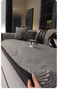 Detail of chenille sofa cover showing grey wave pattern and reinforced black piping edge