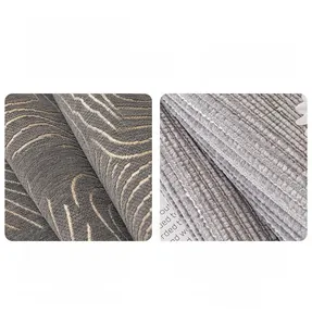 Detail of chenille sofa cover showing thick gray fabric with gold wave pattern