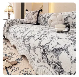 Close-up of thick black and white jacquard fabric with fringe details on a sofa