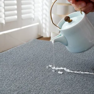 Waterproof teddy velvet sofa cover in dark grey with elegant woven texture and beads of water