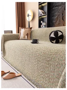 Détail d'une housse de canapé en coton lin épais avec texture tricotée et franges