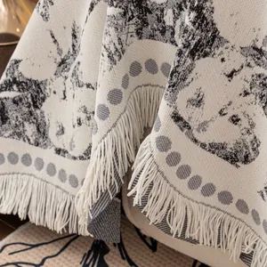French luxury woven sofa throw with floral patterns and delicate fringe borders