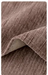 Detail of tan chenille fabric sofa cover featuring handmade edging and ribbed texture