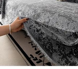 Close-up of grey chenille sofa cover showing embossed texture and fringed edge