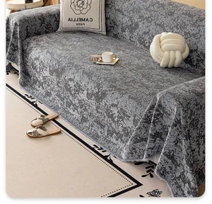 Detailed view of grey chenille sofa cover with marble texture and delicate fringe trim