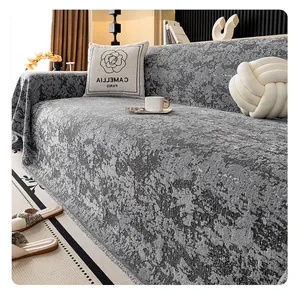 Close-up of grey chenille sofa cover with embossed texture and elegant fringe edges