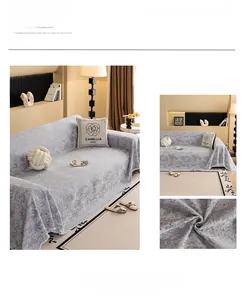 Detail of light grey chenille sofa cover featuring 3D jacquard texture and fringed edges