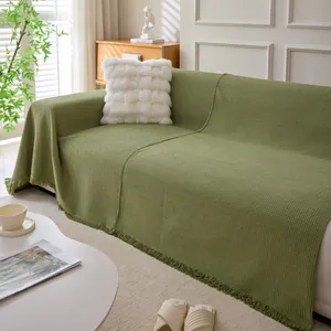 Grass green waffle weave chenille sofa cover with decorative fringe and soft texture