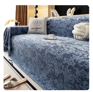 Detail of chenille fabric texture and embossed jacquard pattern on blue sofa cover