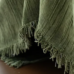 Olive green chenille sofa cover with striped texture and delicate fringe trim details