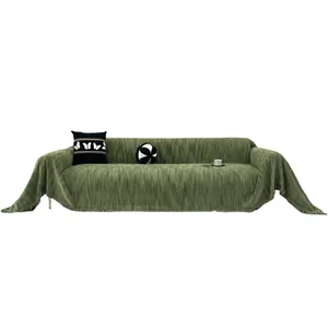 Dark green chenille sofa cover with fringe detail and vertical textured fabric pattern