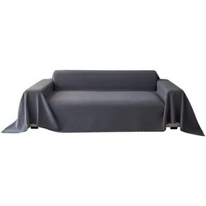 Dark gray waffle-knit chenille sofa cover with fringed edges on white background