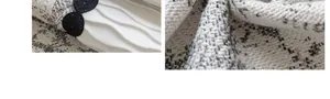 Detail van linnenachtige stof met plooien en zwart gevlochten decoratief accent