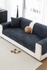 Close-up of thick quilted sofa cover fabric with 3D wave texture and soft plush feel
