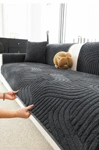 Detail of thick dark grey plush sofa cover showing wave texture and durable hemmed edges