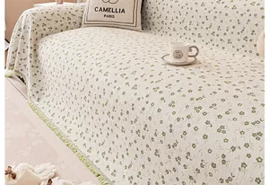 Close-up of floral chenille sofa cover with green fringes and textured fabric