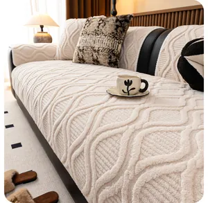 Detail of cream white textured sofa cover with 3D jacquard pattern on black leather sofa