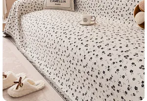 Detail of chenille floral sofa cover with elegant fringe edge and soft fabric texture