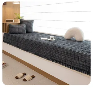 Detailed view of thick dark grey corduroy bay window mat and matching plush cushions