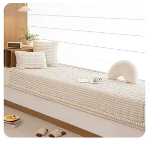 Close-up of cream plush bay window mat with striped texture and matching cushions