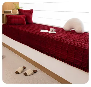 Detail of plush dark red bay window cushion with square quilting and ruffled edges