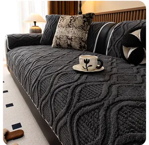 Detail of dark grey plush sofa cover with 3D wave texture and white rope piping