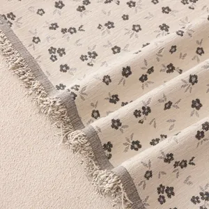 Soft chenille sofa cover with floral patterns and decorative fringe edges in cream white