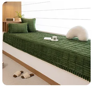 Close-up of deep green plush bay window mat with square textured grid and ruffled edges