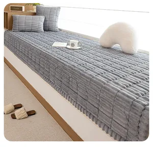 Detail of grey plush bay window mat featuring striped texture and matching soft pillow
