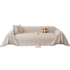 Floral chenille sofa cover with tassels and matching Camellia Paris pillow in cream white