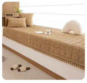 Close-up of brown thickened plush bay window mat with striped texture and matching pillows