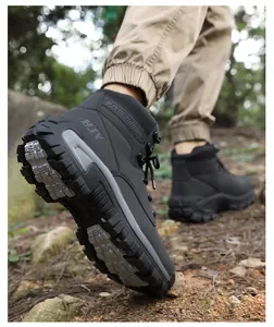 Detail of high-grip rubber sole on black tactical hiking boots during outdoor trek